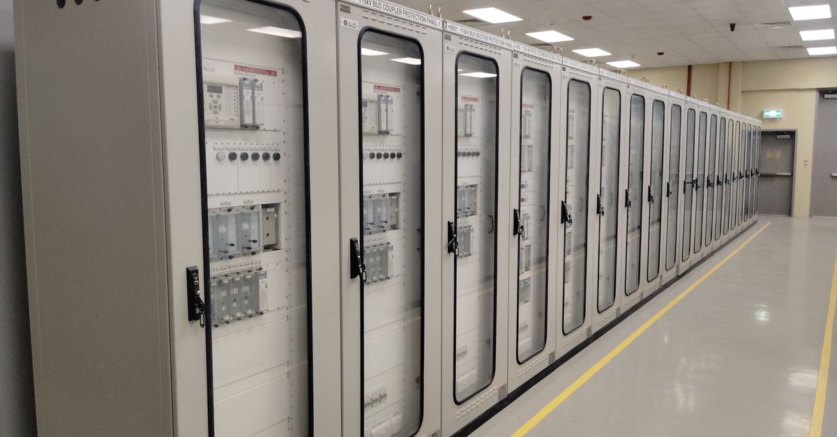 Iso 50001 Enerji Yönetim Sistemi Sertifikası 1 İyi aydınlatılmış bir ortamda elektrik panellerinin sıralandığı endüstriyel bir kontrol odasının görünümü.